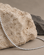 Collar blanco RITA de Sibela con diseño rivière y piedras brillantes en una línea continua.