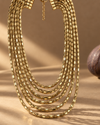Collar PEDRI ajustable con siete tiras de cadena dorada y cierre con broche.