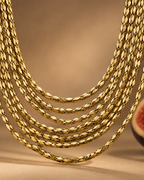 Collar PEDRI con cadenas doradas dispuestas en capas para aportar movimiento y volumen.