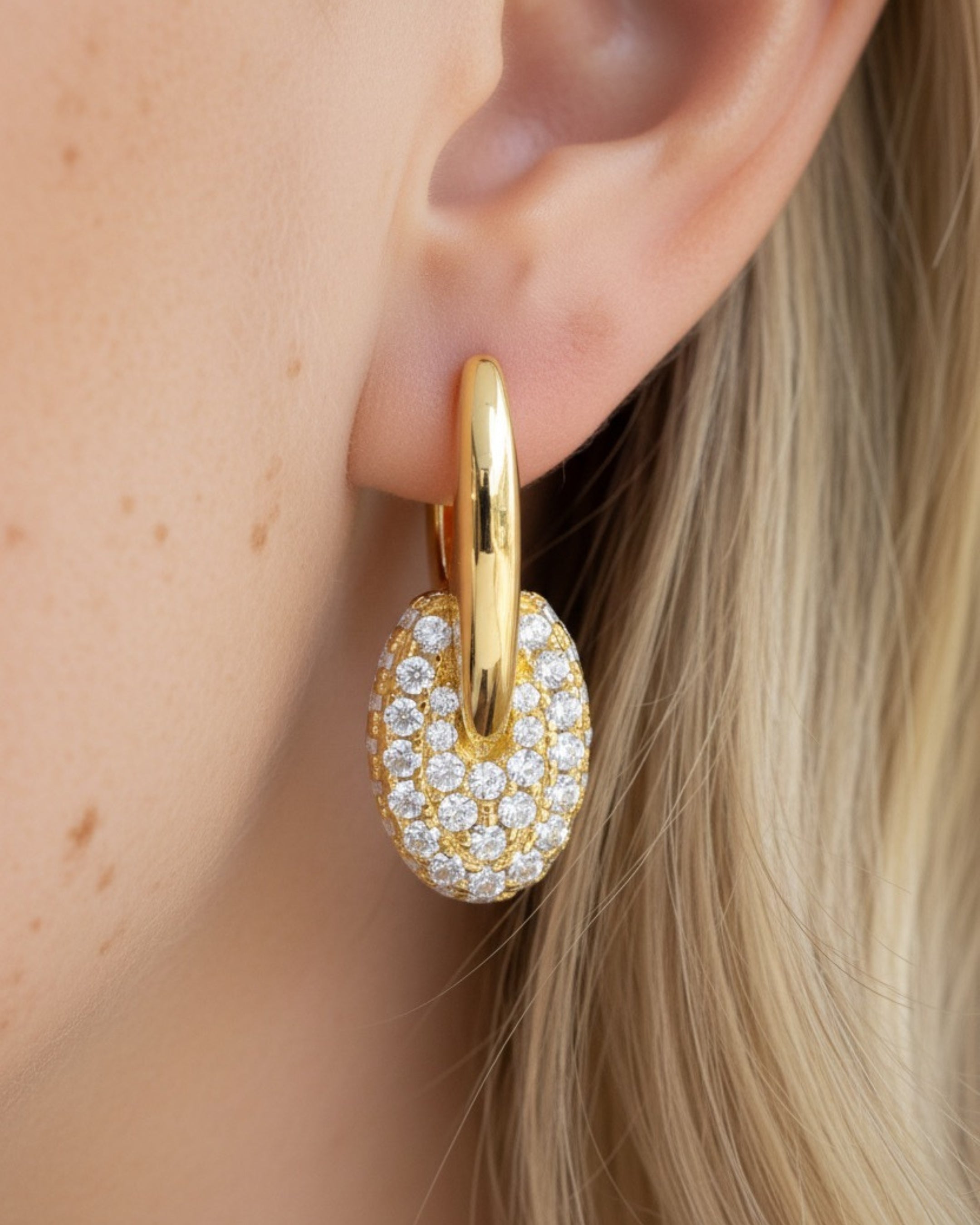 Pendientes de colores con pequeñas piedras blancas que crean un diseño elegante y luminoso.