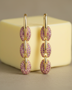 Pendientes dorados para mujer con piedras rosas y diseño moderno y femenino.