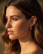 Pendientes dorados con esmalte coral y estilo femenino y sofisticado.