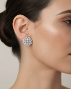 Detalle de los pendientes Líridas con piedras en talla circular que reflejan la luz con intensidad.