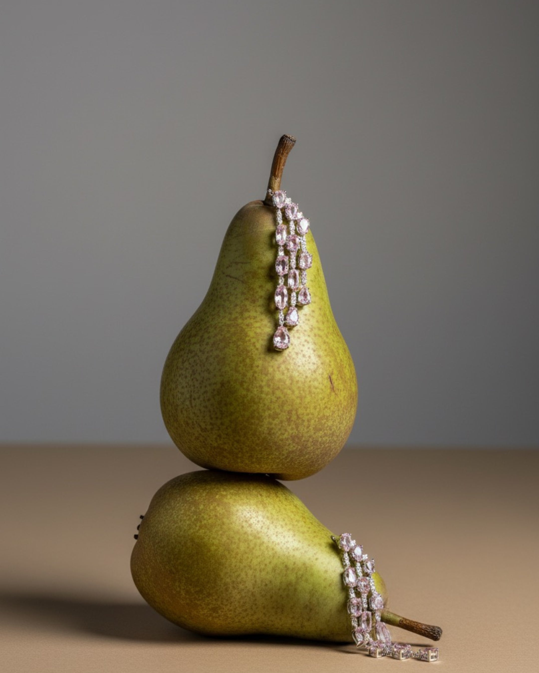 Vista frontal de los pendientes Medusa con piedras rosas y detalles luminosos que realzan el diseño.