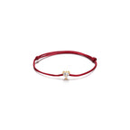 Pulsera Áine con hilo rojo, corazón brillante y acabado en oro amarillo de 18 kt.
