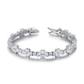 Pulsera Canna con flores brillantes y acabado elegante en rodio.