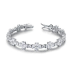 Pulsera Canna con flores brillantes y acabado elegante en rodio.